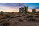 Two-story house exterior, gray siding, attached garage, and desert landscaping at 27 N Muleshoe Rd, Apache Junction, AZ 85119