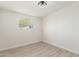 Bright bedroom with wood-look floors and window at 3801 W Golden Ln, Phoenix, AZ 85051