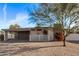 Mid-century modern home with carport and charming landscaping at 3801 W Golden Ln, Phoenix, AZ 85051