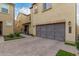 Tan-colored stucco home with gray garage doors and landscaped walkway at 3915 E Megan St, Gilbert, AZ 85295