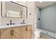 Modern bathroom with wood vanity, marble countertop, and walk-in shower at 4057 E Karen Dr, Phoenix, AZ 85032