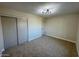 Bright bedroom, featuring neutral carpeting and double doors at 4057 E Karen Dr, Phoenix, AZ 85032