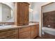 Double vanity bathroom with a large cabinet and shower at 45425 N 14Th St, New River, AZ 85087