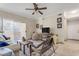 Living room with sliding glass doors, a sofa, and wicker chairs at 5401 E Van Buren St # 1006, Phoenix, AZ 85008