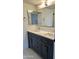 Modern double vanity with dark grey cabinets and rectangular mirrors at 6891 W Via Del Sol Dr, Glendale, AZ 85310