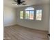 Well-lit bedroom with wood floors and large windows at 6891 W Via Del Sol Dr, Glendale, AZ 85310