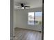 Bright bedroom with wood-look floors and ceiling fan at 6891 W Via Del Sol Dr, Glendale, AZ 85310