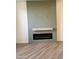 Modern electric fireplace with textured green wall at 6891 W Via Del Sol Dr, Glendale, AZ 85310