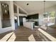 Bright kitchen with an island, stainless steel appliances, and a view of the staircase at 6891 W Via Del Sol Dr, Glendale, AZ 85310