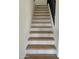 Modern staircase with wood steps and light grey risers at 6891 W Via Del Sol Dr, Glendale, AZ 85310