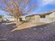 Backyard view showing patio, shed, and gravel landscaping at 724 N 66Th Pl, Mesa, AZ 85205