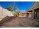 Large backyard with covered patio, block wall, and small tree at 10350 W Foothill Dr, Peoria, AZ 85383