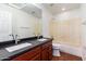 Bathroom boasts double sinks, dark countertop and a bathtub at 10350 W Foothill Dr, Peoria, AZ 85383