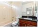 Clean bathroom with a tub, toilet, and dark vanity at 10350 W Foothill Dr, Peoria, AZ 85383