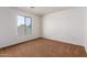 Bright bedroom featuring brown carpet and a large window at 10350 W Foothill Dr, Peoria, AZ 85383