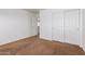 Spacious bedroom with brown carpet and a door to hallway at 10350 W Foothill Dr, Peoria, AZ 85383