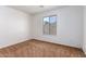 Bright bedroom with brown carpet and a large window at 10350 W Foothill Dr, Peoria, AZ 85383