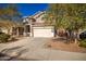 Two-story house with a tan colored garage door and driveway at 10350 W Foothill Dr, Peoria, AZ 85383
