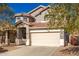 Two-story house with a beige colored garage door and small yard at 10350 W Foothill Dr, Peoria, AZ 85383