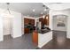 Modern kitchen with dark wood cabinets and a breakfast bar at 10350 W Foothill Dr, Peoria, AZ 85383