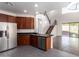 Modern kitchen with island, stainless steel appliances, and view into living room at 10350 W Foothill Dr, Peoria, AZ 85383