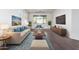 Living room with hardwood floors, stylish furniture, and large TV at 10350 W Foothill Dr, Peoria, AZ 85383