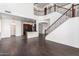 Two story living room with hardwood floors, open concept kitchen and staircase at 10350 W Foothill Dr, Peoria, AZ 85383