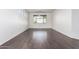 Large living room with dark hardwood floors and a window at 10350 W Foothill Dr, Peoria, AZ 85383