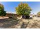 View of the back of the house with a large tree in the yard at 10428 W Camelot Cir, Sun City, AZ 85351