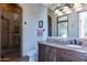 Elegant bathroom with a walk-in shower, granite vanity, and dark wood cabinets at 10742 E Greythorn Dr, Scottsdale, AZ 85262