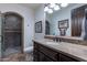 Bathroom with a walk-in shower, granite countertop, and dark wood cabinets at 10742 E Greythorn Dr, Scottsdale, AZ 85262