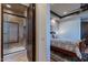 Small bathroom with shower/tub combo and dark wood door at 10742 E Greythorn Dr, Scottsdale, AZ 85262