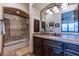 Bathroom with granite vanity, tiled shower, and dark wood cabinets at 10742 E Greythorn Dr, Scottsdale, AZ 85262