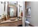 Upscale bathroom with stone sink, tile, and decorative lighting at 10742 E Greythorn Dr, Scottsdale, AZ 85262