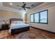 Main bedroom with wood floors, large windows, and a comfortable bed at 10742 E Greythorn Dr, Scottsdale, AZ 85262