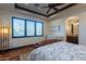 Spacious bedroom with wood floors, plantation shutters, and en-suite bathroom at 10742 E Greythorn Dr, Scottsdale, AZ 85262