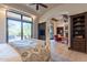 Spacious bedroom with access to a private patio and sitting area at 10742 E Greythorn Dr, Scottsdale, AZ 85262