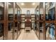 Spacious walk-in closet with mirrored doors and custom shelving at 10742 E Greythorn Dr, Scottsdale, AZ 85262