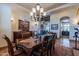 Spacious dining room with a large wooden table and chandelier at 10742 E Greythorn Dr, Scottsdale, AZ 85262