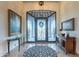 Elegant entryway with ornate iron door and decorative console tables at 10742 E Greythorn Dr, Scottsdale, AZ 85262