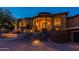 Stunning home exterior at night with beautiful landscaping at 10742 E Greythorn Dr, Scottsdale, AZ 85262