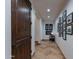 Long hallway with tiled floors and framed pictures on the wall at 10742 E Greythorn Dr, Scottsdale, AZ 85262