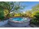 Private hot tub surrounded by desert landscaping at 10742 E Greythorn Dr, Scottsdale, AZ 85262