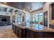 Large kitchen island with granite countertops and a built-in sink at 10742 E Greythorn Dr, Scottsdale, AZ 85262