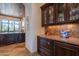 Elegant kitchen boasts dark wood cabinets, granite counters, and ample storage at 10742 E Greythorn Dr, Scottsdale, AZ 85262