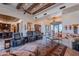 Open living room with high ceilings, exposed beams, and comfortable seating at 10742 E Greythorn Dr, Scottsdale, AZ 85262