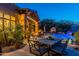 Backyard patio with fire pit and dining area at 10742 E Greythorn Dr, Scottsdale, AZ 85262