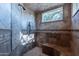 Spa-like shower with tiled walls and built-in seating at 10742 E Greythorn Dr, Scottsdale, AZ 85262