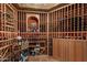 Impressive wine cellar with extensive wooden racking for bottles at 10742 E Greythorn Dr, Scottsdale, AZ 85262