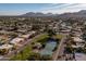 Community view with tennis courts, homes, and mountain backdrop at 10801 N 45Th St, Phoenix, AZ 85028